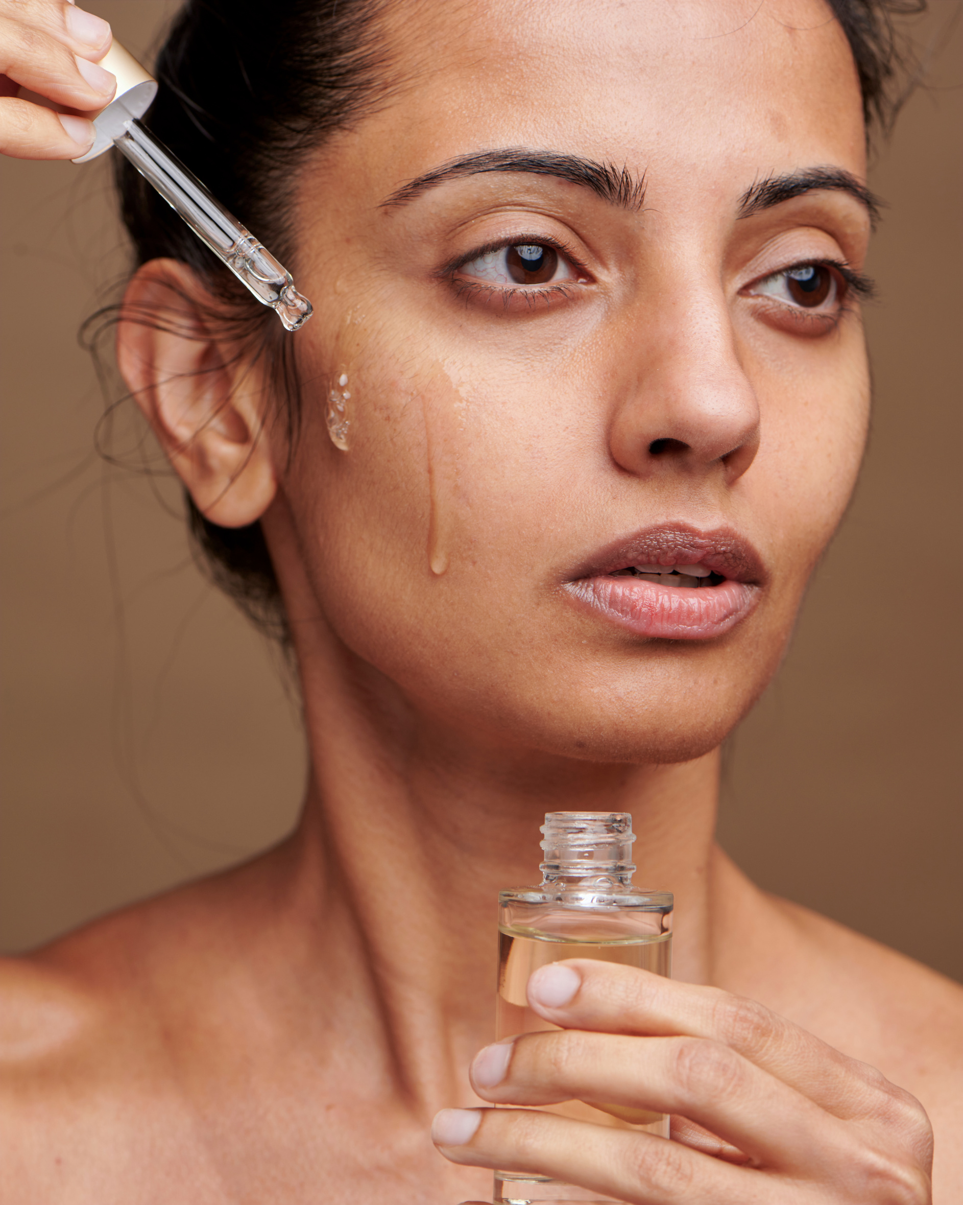 Woman Applying Serum on Face